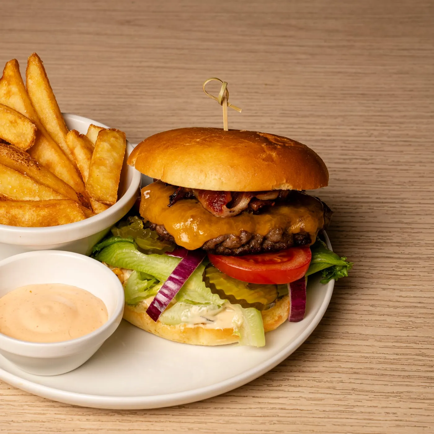 Burger with gourmet fries and dip.