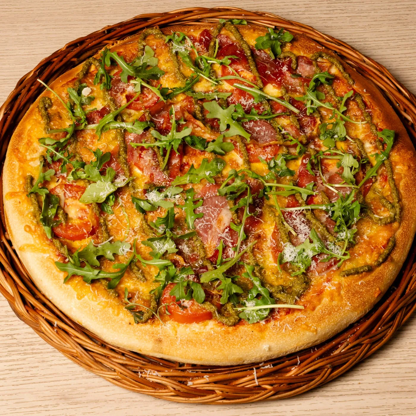 Parma pizza with rocket, parma ham and pesto.